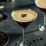 Espresso martini mocktail with frothy top and coffee beans