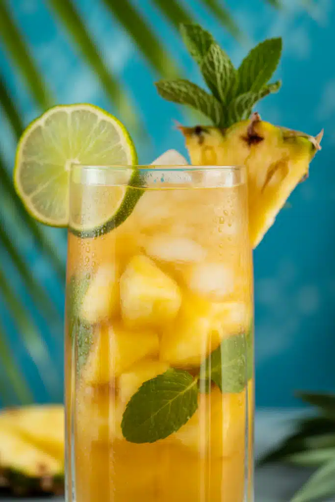 Close-up of Pineapple Mocktail with pineapple and lime garnish