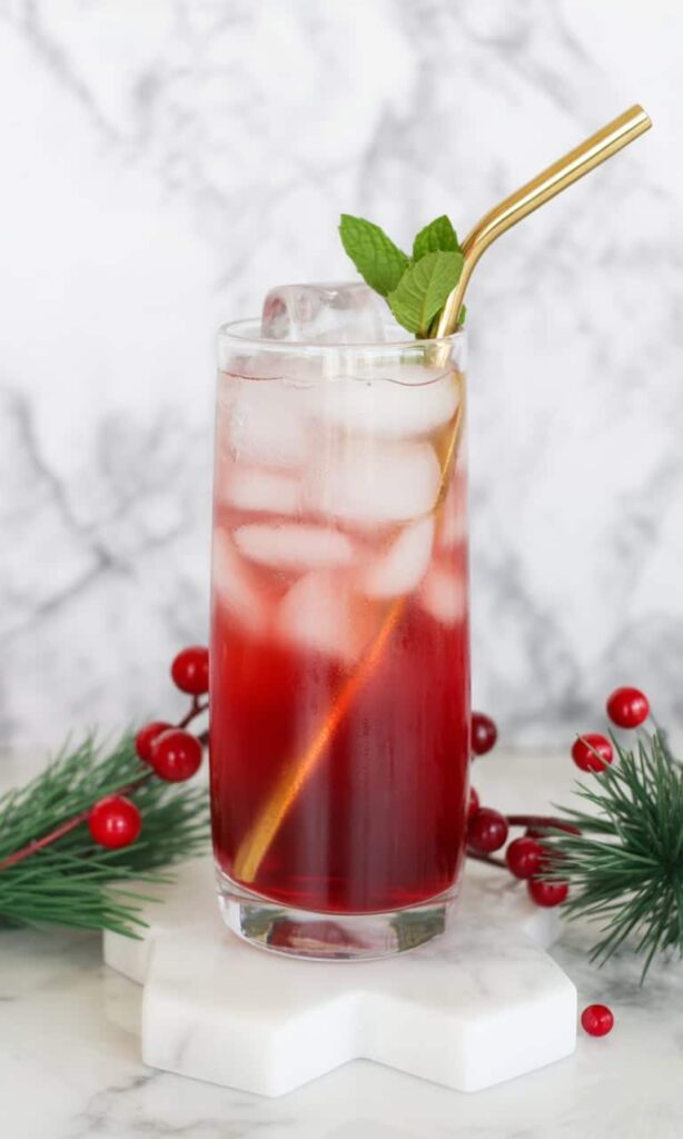 Cranberry juice mocktail in stemmed glass with sugared cranberry garnish