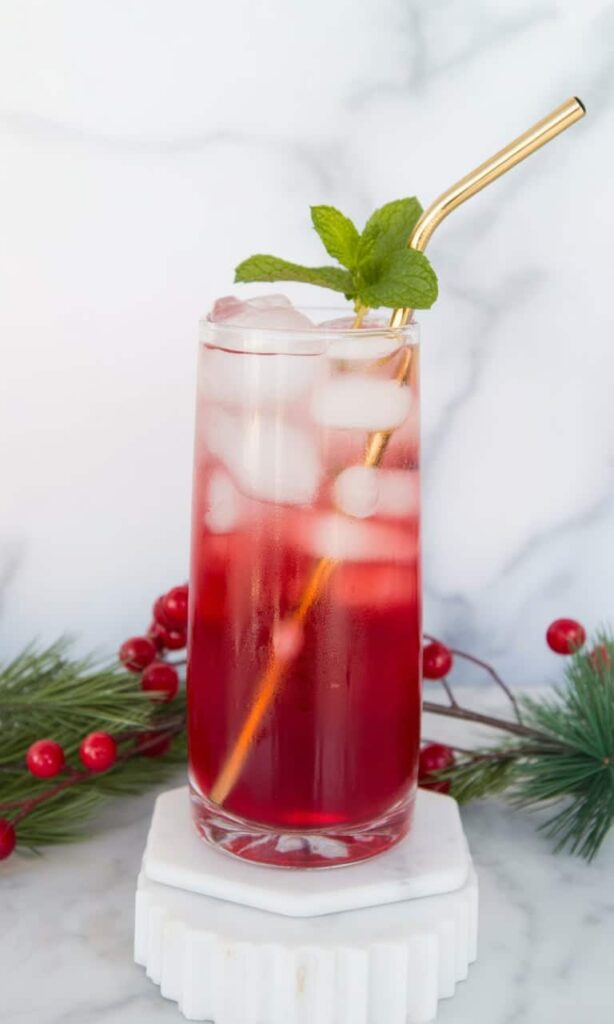 Cranberry juice mocktail in stemmed glass with sugared cranberry garnish