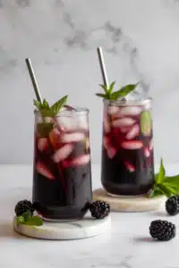 Blackberry mojito mocktail close-up with mint and lime