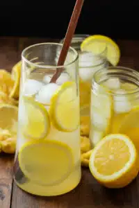 Easy lemonade recipe close-up with fresh lemons, juicer, and glass