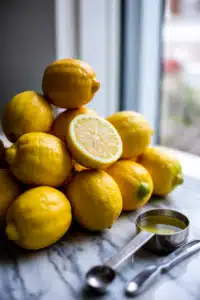 How many lemons to make lemonade — close-up of fresh lemons and juicer
