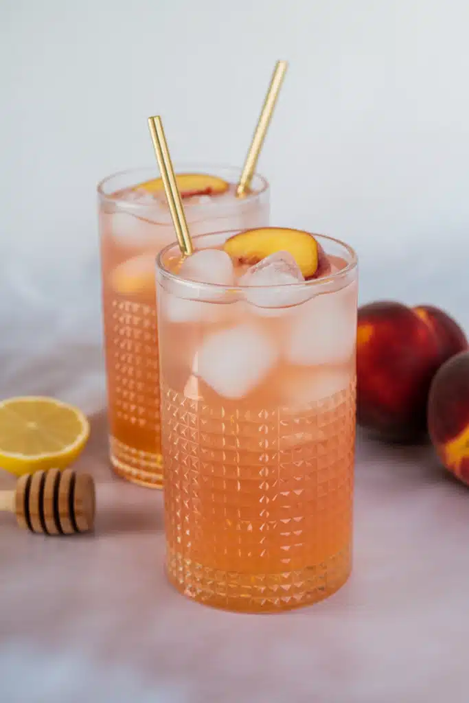 Peach lemonade with peach slices, lemon wheels, and mint