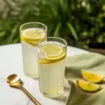 Perfect lemonade recipe close-up with lemon slice, mint, and condensation
