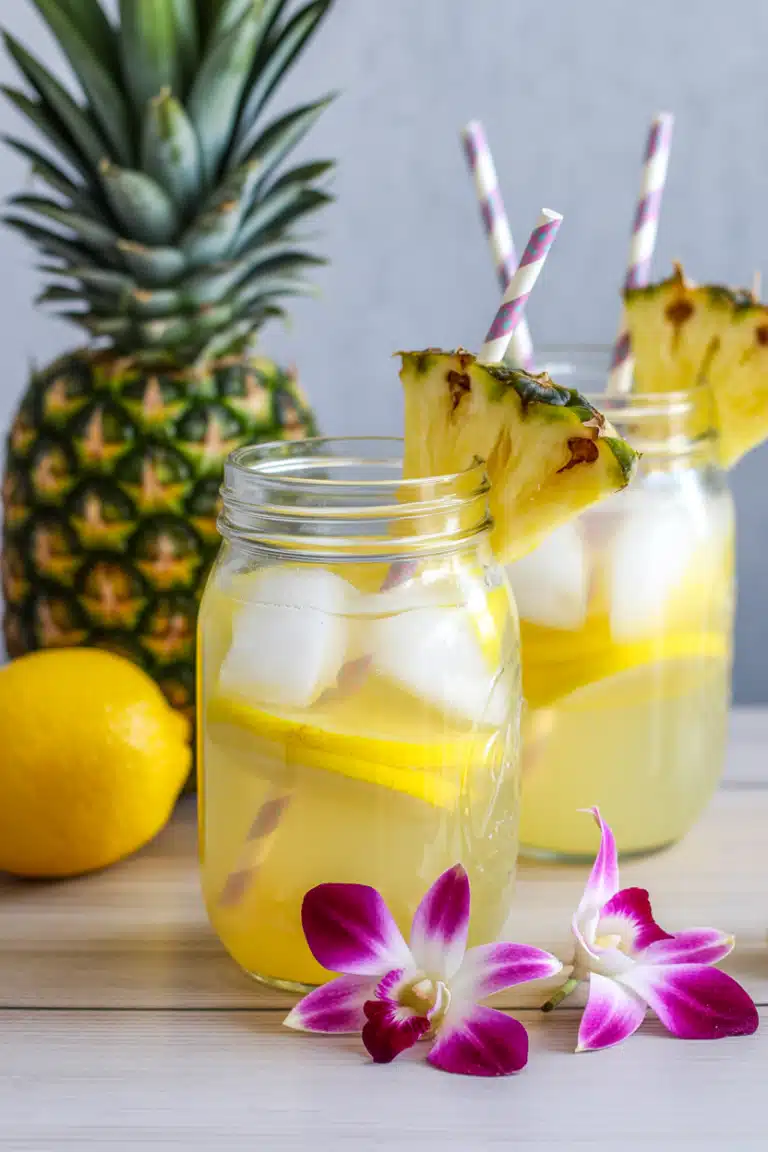 Close-up of pineapple lemonade with pineapple and lemon garnish