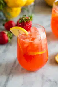 Close-up strawberry lemonade with lemon slice, strawberry, and mint